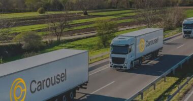 Carousel Branded White Trucks On Motorway