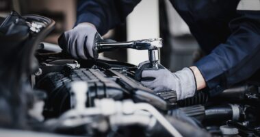 Car Mechanic Repairing An Engine