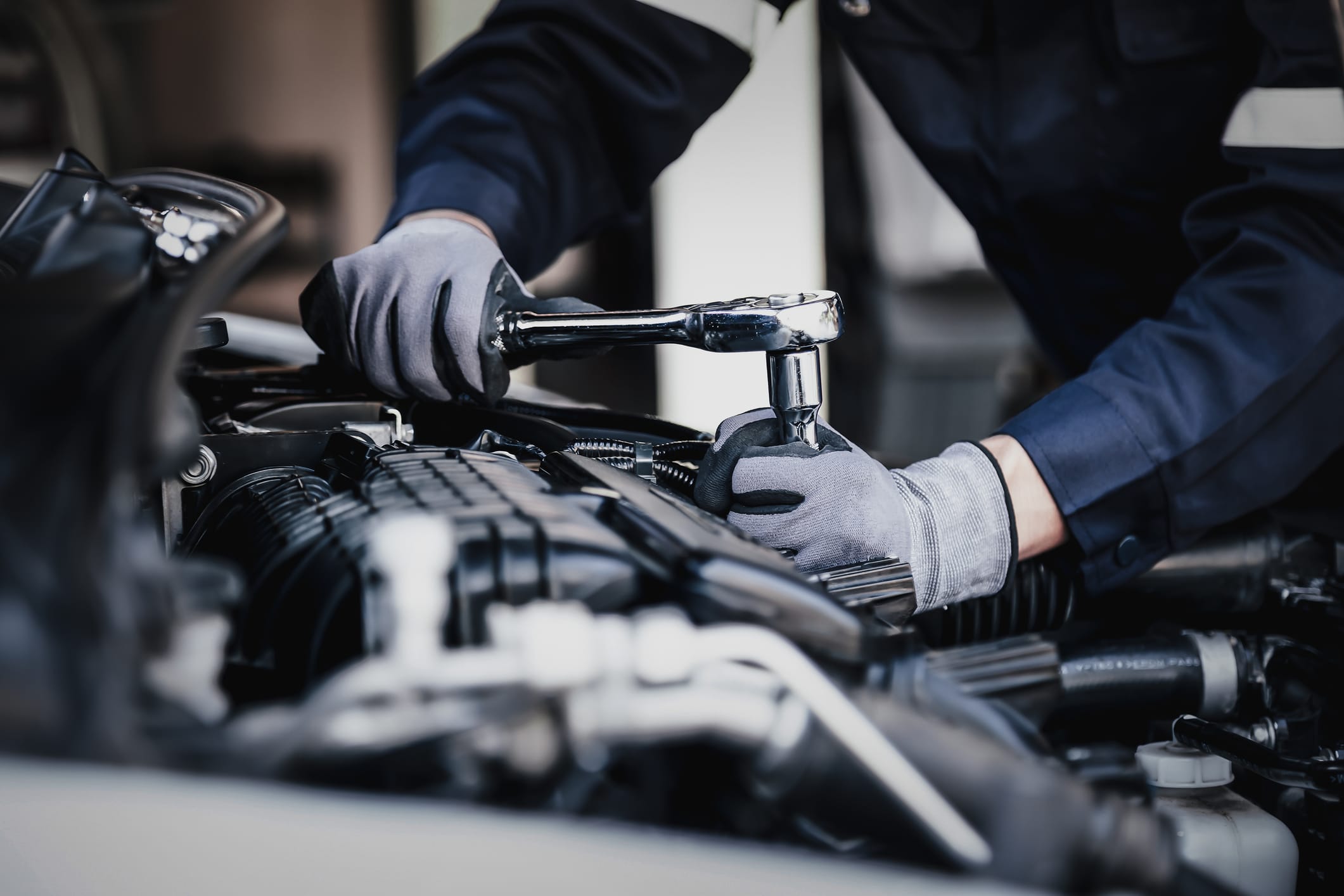 car mechanic repairing an engine