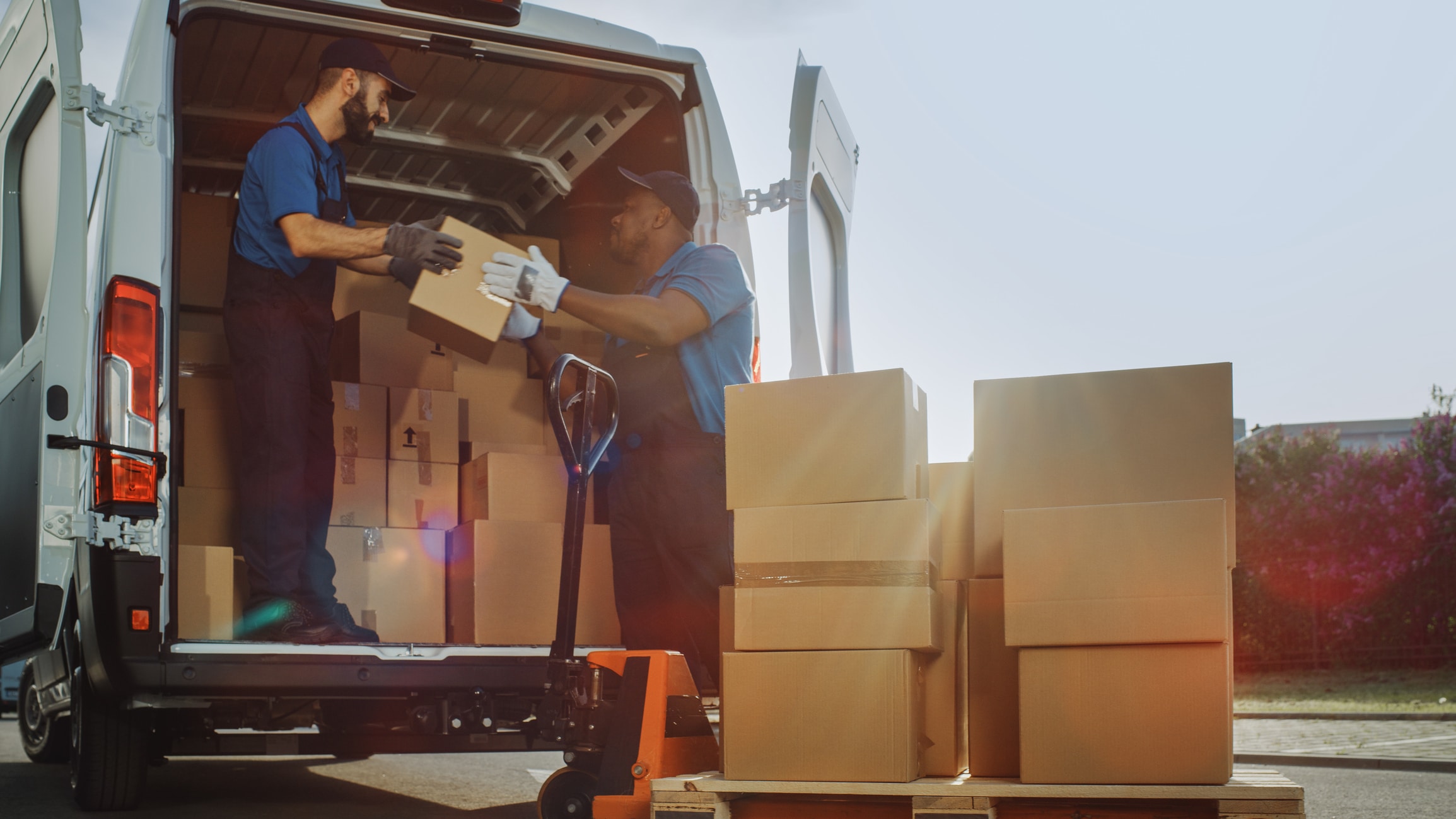 Two delivery people loading a van with last mile deliveries for PUDO points
