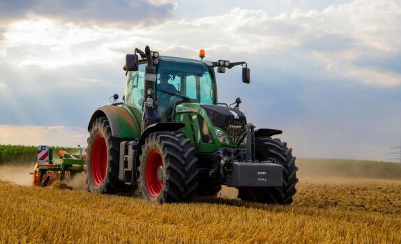 farming-logistics A green tractor in a crop field